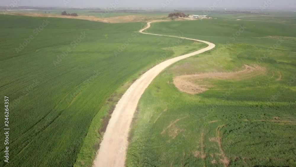 Lush green Badlands with dirt trail along the fields - Aerial footage. Lush green Badlands with dirt trail along the fields - Aerial footage.