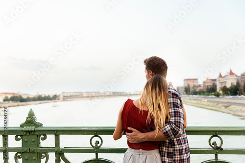 Photography Young loving couple hugging in the street.