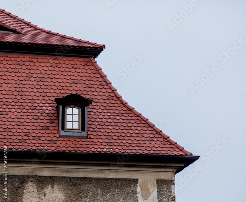 One small window in a roof a castle in Poland, Europe