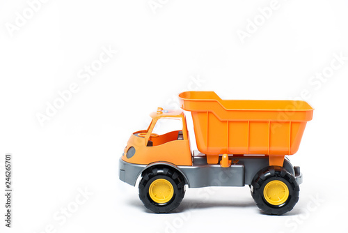  Plastic toy yellow truck on a white background. Close-up.