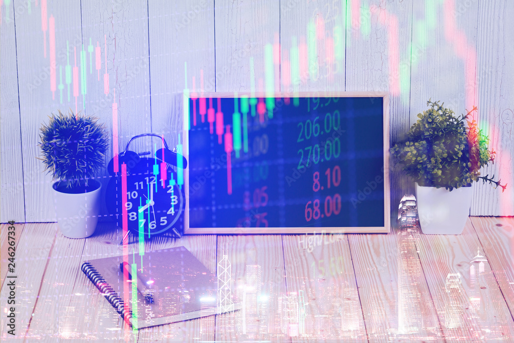 Double exposure of alarm clock with green chalkboard, notebook and financial graph, with candle stick and stock market screen, business planning vision and finance analysis.