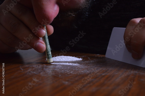 Canvastavla Person with a dollar bill snorting cocaine