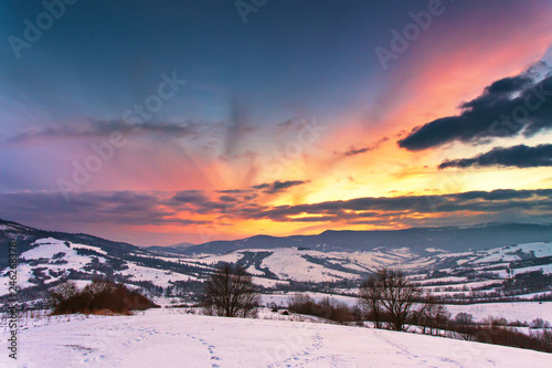 Fototapeta Naklejka Na Ścianę i Meble -  Winter mountain sunset. Colorful overcast sky