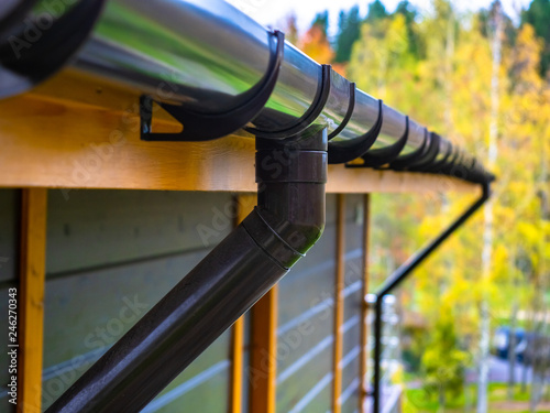 Holder gutter drainage system on the roof. Drain on the roof of the house. Roof drainage. Water drainage from the roof. photo