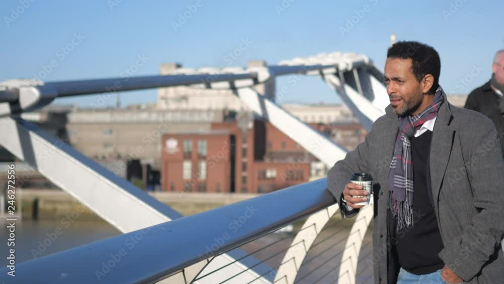 African black man enjoys the view over River Thames London from Millennium Bridge African black man enjoys the view over River Thames London from Millennium Bridge