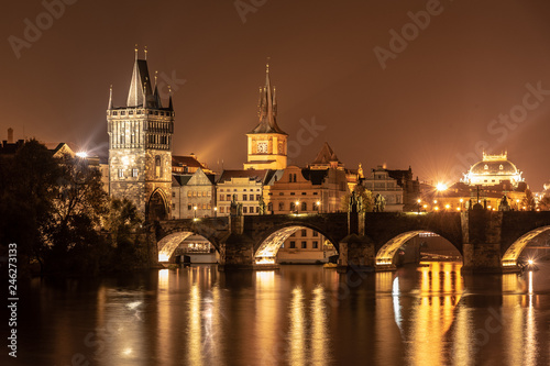 Vltava River and Charles Bridge with Old Town Bridge Tower by night, Prague, Czechia. UNESCO World Heritage Site