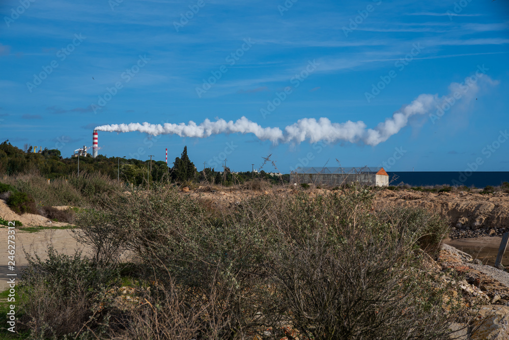 factory chimneys with one long line of smoke