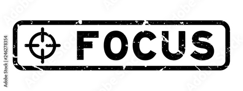 Grunge black focus word with scope icon square rubber seal stamp on white background