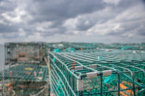 lobster cages stacked with stormy sky in background photo