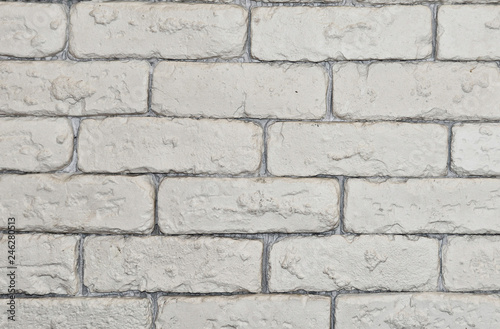 Beautiful background of a white brick wall. Textured structure. Decorative abstract design. Image of a beautiful brickwork.