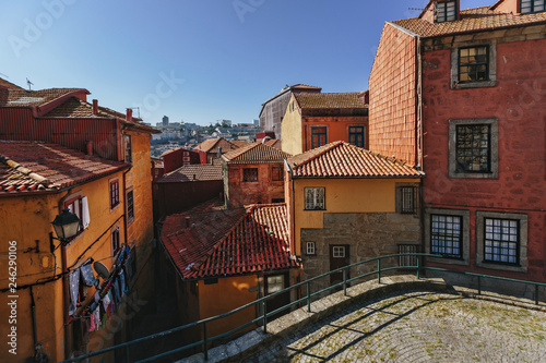 Fototapeta Naklejka Na Ścianę i Meble -  Red and orange color houses in European city view. Porto, Portugal, small casual streets in old center
