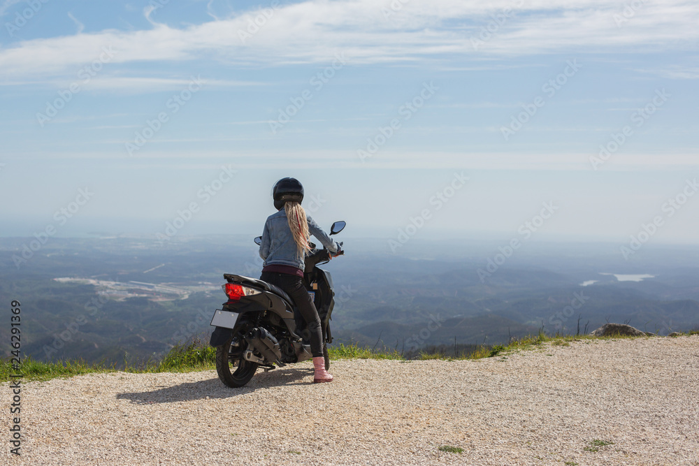 Woman with long white hair dreads travel by scooter in european mountains Woman with long white hair dreads travel by scooter in european mountains