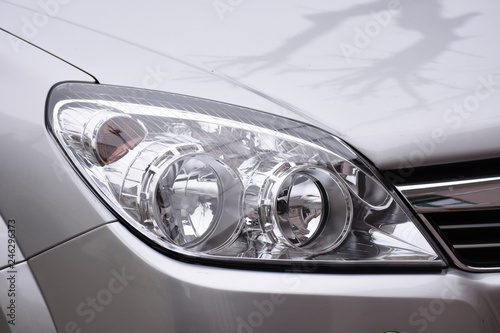 shiny headlight on a  silver  car © Laurenx