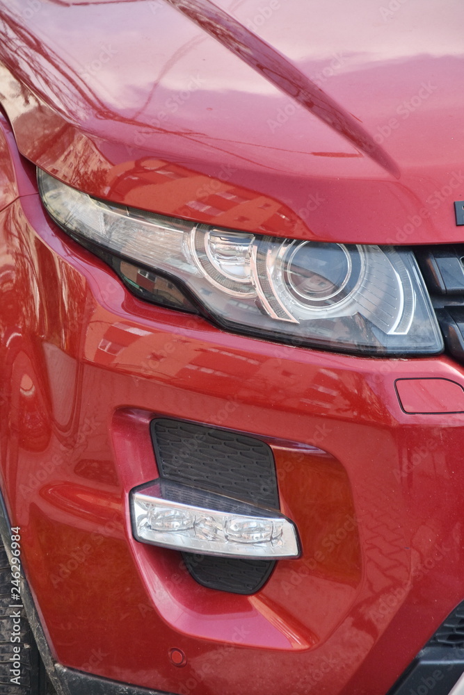  Car's exterior details. shiny headlights on a red car
