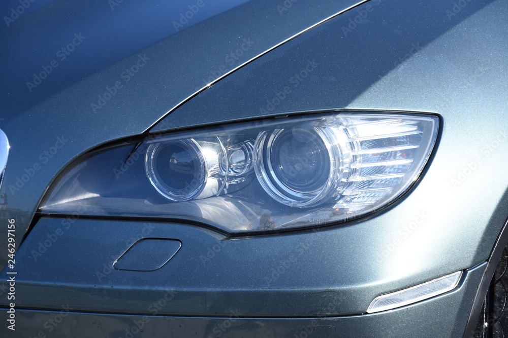  Car's exterior details. shiny headlights on a new car