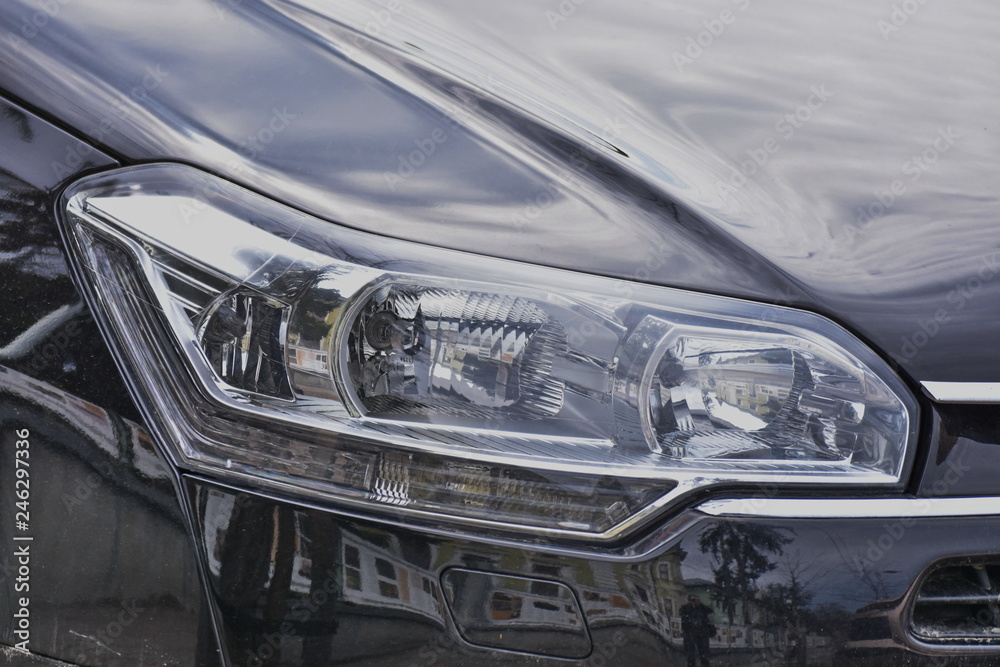  Car's exterior details. shiny headlights on a  gray car