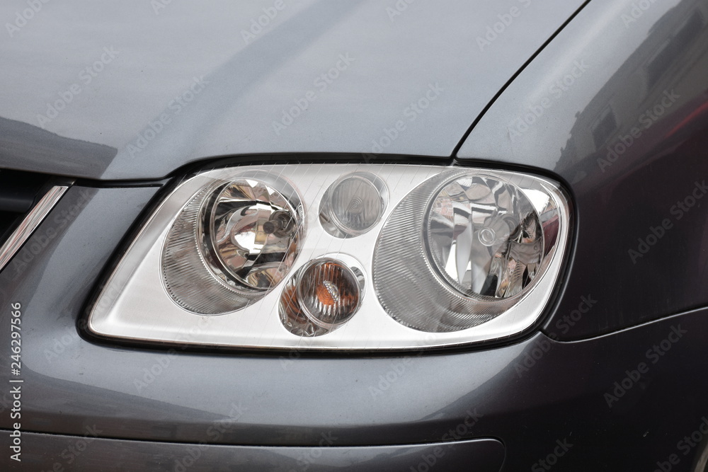  Car's exterior details. shiny headlights on a  gray car