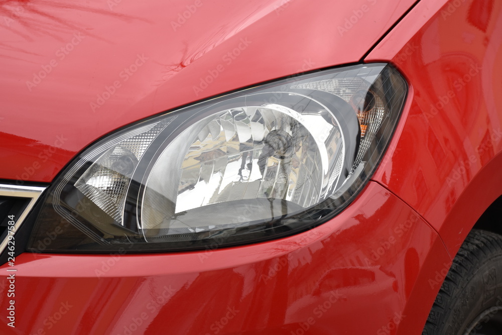 shiny headlights on a red  car