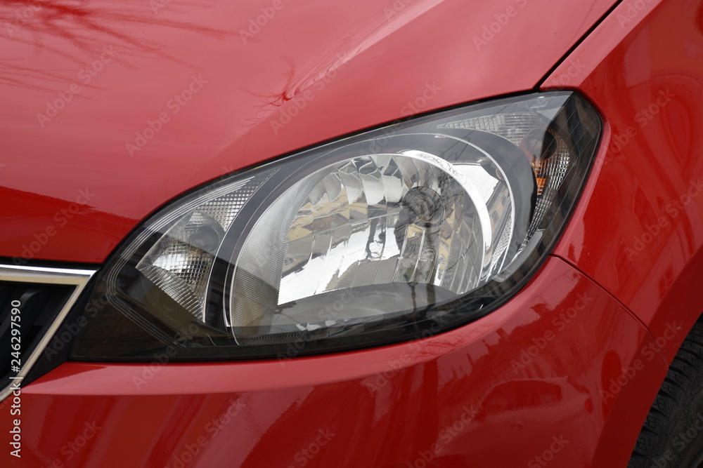shiny headlights on a red  car
