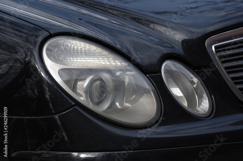 Car'sCar exterior detail.shiny headlight on a black car exterior detail, headlight on a new car