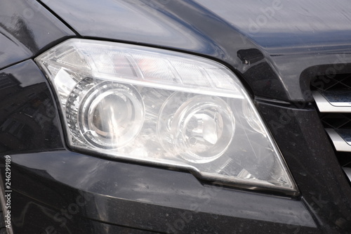 Car'sCar exterior detail.shiny headlight on a black  car exterior detail, headlight on a  new car © Laurenx