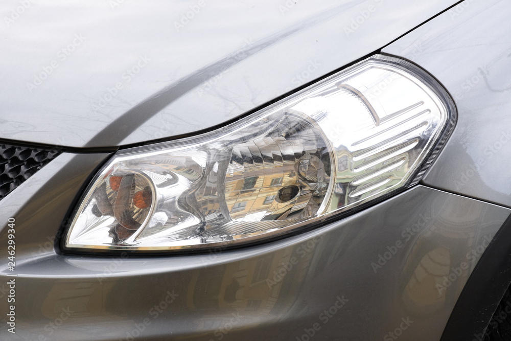 Car's exterior detail, headlight on a  silver car