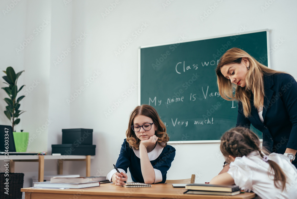 Education school lesson female teacher with pupils Education school lesson female teacher with pupils