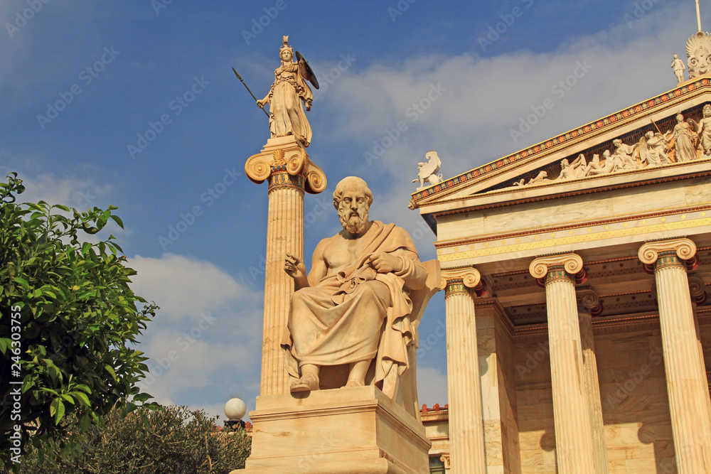 Statues of Plato and Athena at the National Academy of Arts in Athens, Greece with blue sky copy space.