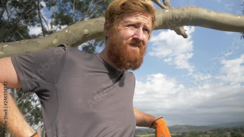 Slow motion close up of a farmer looking around and reflecting after tiresome work.
