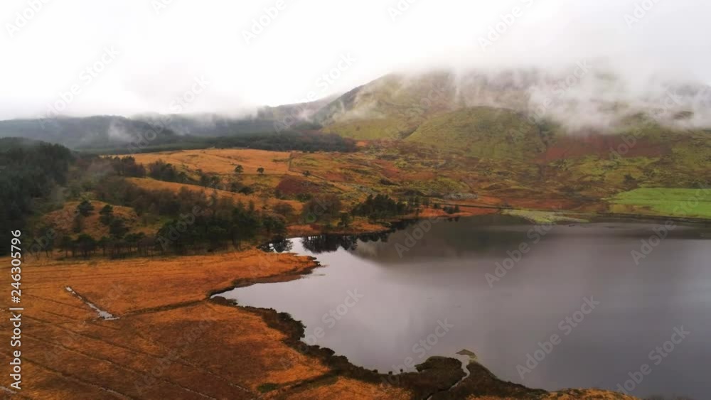 Beautiful pond in the mountains of Snowdonia National Park in Wales aerial flight footage Beautiful pond in the mountains of Snowdonia National Park in Wales aerial flight footage