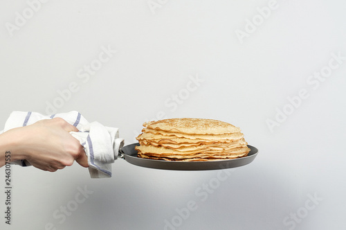Obraz na płótnie Stack of russian pancake blini in pan woman holds in hands w salonie