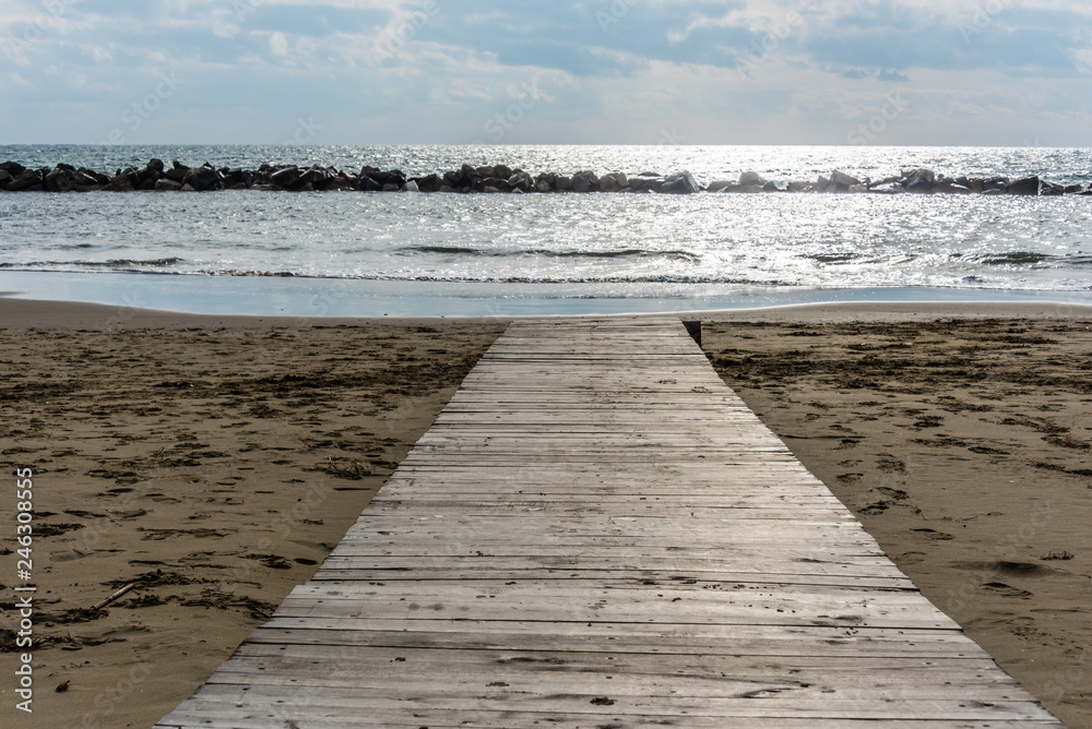 Wooden Walkway on an Italian Beach Out to the Mediterranean Sea Wooden Walkway on an Italian Beach Out to the Mediterranean Sea