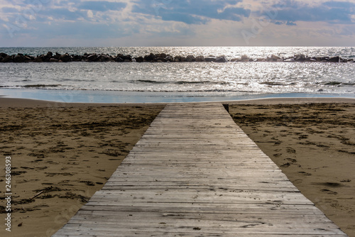 Wooden Walkway on an Italian Beach Out to the Mediterranean Sea