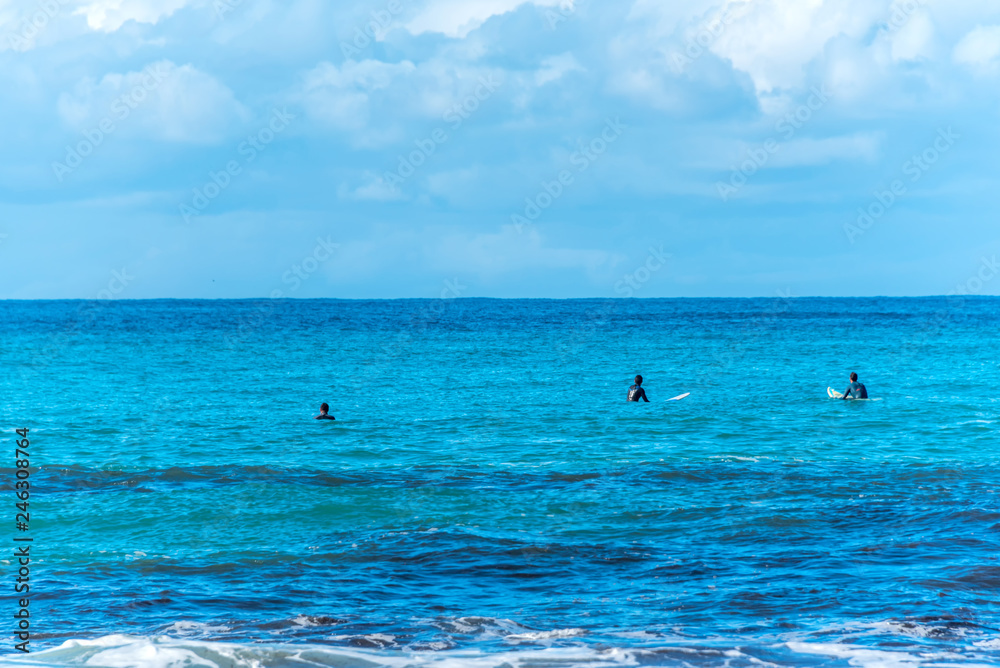 indistinct Surfers in the Blue Mediterranean Sea