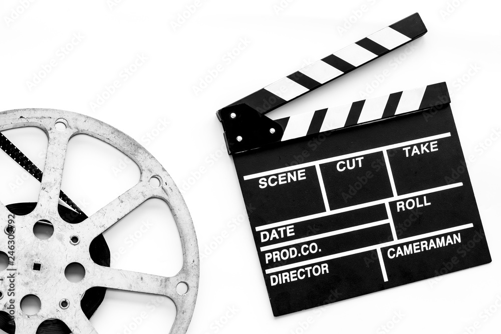 Filmings concept. Clapperboard and film stock on white background top view space for text