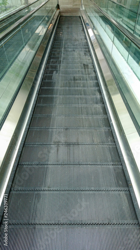 Empty escalator moving walkway © Rawich Liwlucksaneey