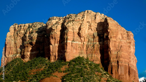 Redrock with green foliage and blue skies