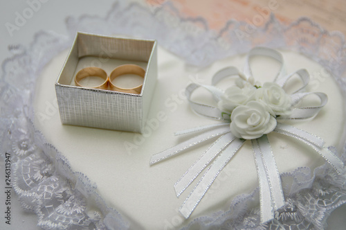 Gold wedding rings in box on the. tableWedding accessories.