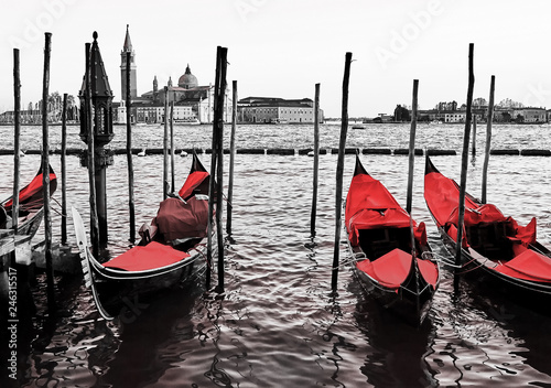 Blue old gondolas  docked at the pier the Piazza San Marco in Venice, Italy. Color in black and white