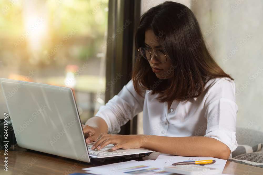 Asia woman using personal computer working in free time with happy. Asia woman using personal computer working in free time with happy.
