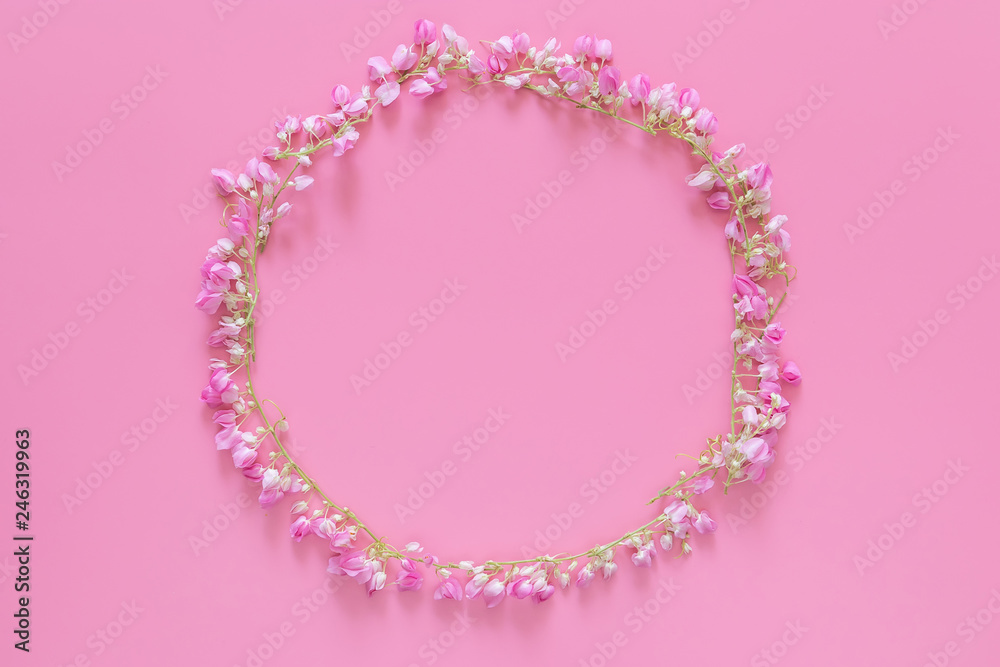 flat lay of Flower crown ,floral wreath circle made from pink flowers isolated on pink background, top view. flower creative composition with copy space