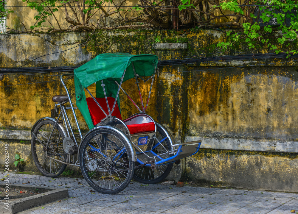 Cyclo (rickshaw) on street in Hoi An, Vietnam