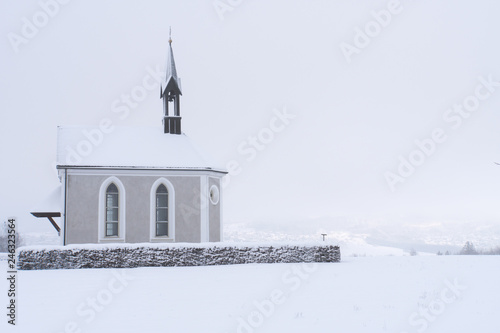 Winter Switzerland fairytale chapel on hill 