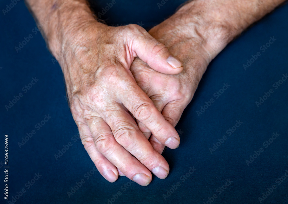 Hands of an elderly man folded together in close-up background Hands of an elderly man folded together in close-up background