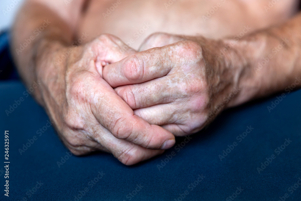 Hands of an elderly man folded together in close-up background Hands of an elderly man folded together in close-up background