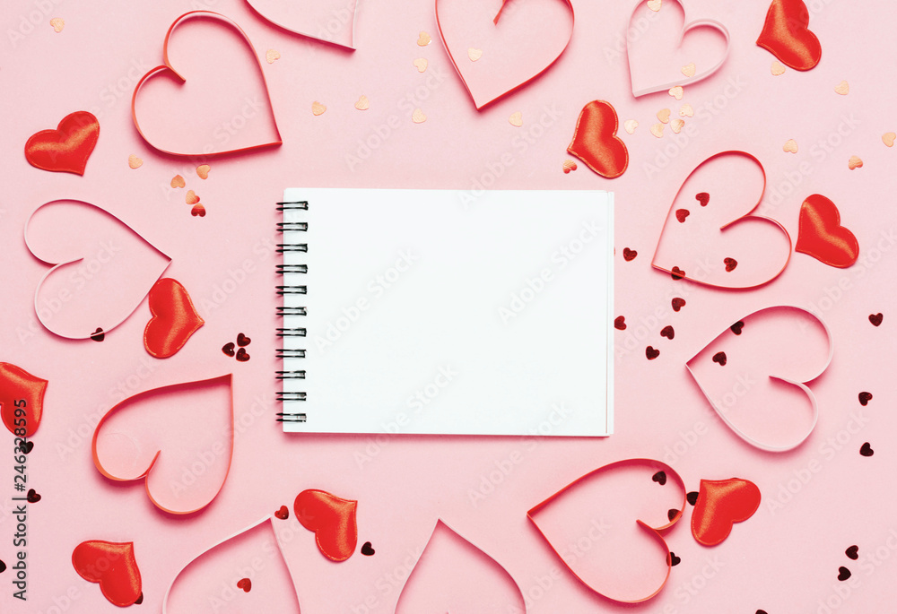Valentine's day background. Little red hearts on pink background and empty notepad.. Valentine's day background. Little red hearts on pink background and empty notepad..