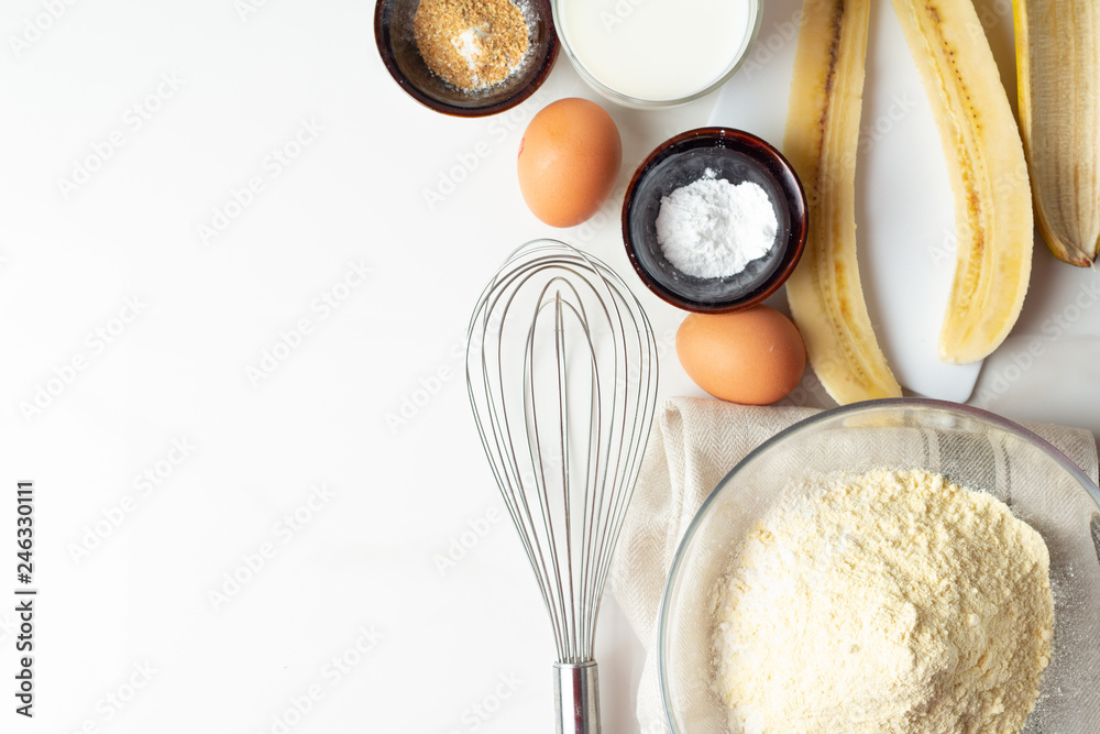 ingredients for baking with banana on white background close-up. ingredients for baking with banana on white background close-up.