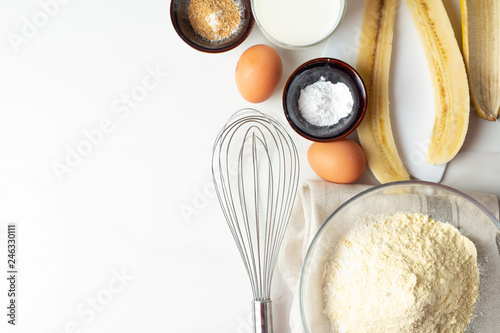 ingredients for baking with banana on white background close-up.