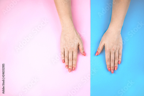 Lovely young woman s hands on colored background.