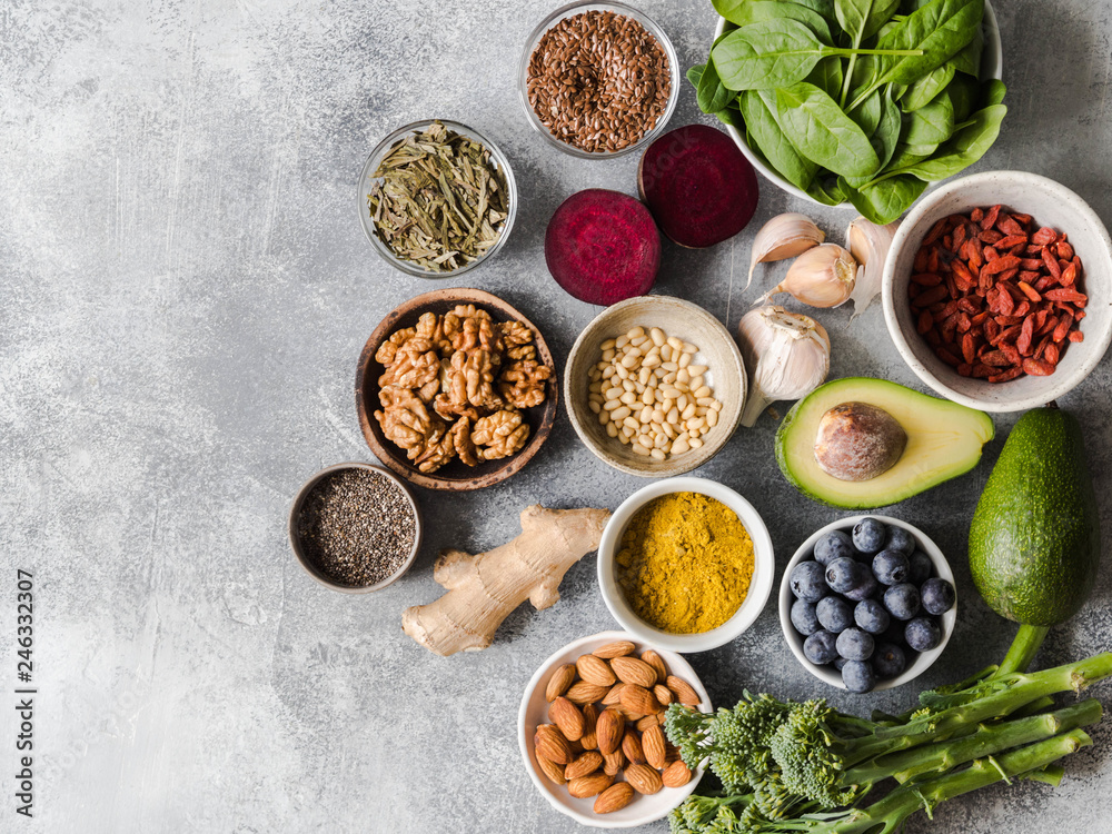 Healthy clean food - vegetables, fruits, nuts, superfoods on a gray background. Healthy eating concept. Top view.